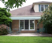 residential awning with green and white stripes